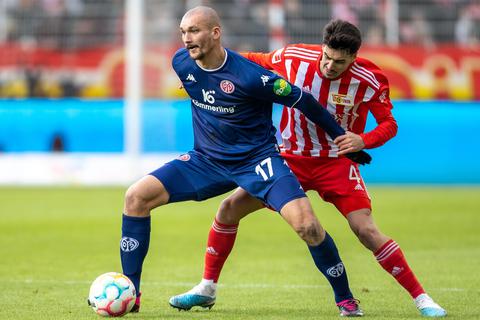 Ludovic Ajorque (l) von FSV Mainz 05 kämpft gegen Berlins Diogo Leite (r) um den Ball.