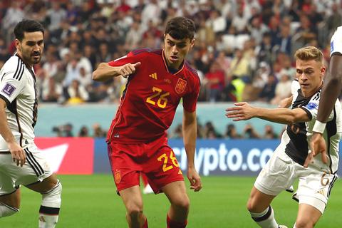 Deutschlands Ilkay Gündogan, Spaniens Pedri und Deutschlands Joshua Kimmich (v.li.) kämpfen in der Vorrunde der WM 2022 in Katar um den Ball.  